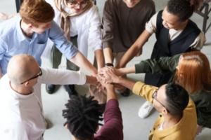 Employees in a circle with hands in the middle