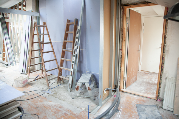 A room being renovated with ladders in background