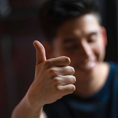 Close up of man giving the thumbs up sign