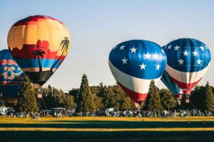Hot air balloons being inflated in a field, photo by Brett Sayles.